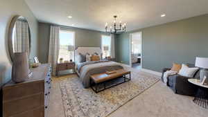 Carpeted bedroom with ensuite bath, a chandelier, and a textured ceiling