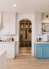 Mudroom with sink and light hardwood / wood-style flooring