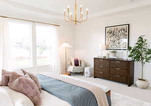 Bedroom with light colored carpet, a chandelier, and multiple windows