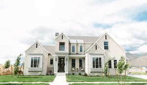 View of front of house featuring a mountain view and a front yard
