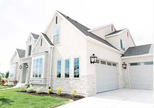 View of front facade featuring a garage and a front yard