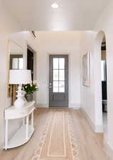 Foyer with a wealth of natural light and light hardwood / wood-style flooring