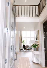 Foyer featuring plenty of natural light, light hardwood / wood-style floors, and a high ceiling