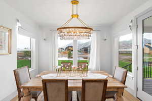 Dining room featuring a chandelier, a mountain view, and light hardwood / wood-style flooring