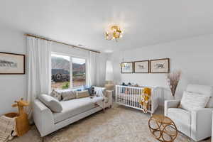 Bedroom featuring a notable chandelier and a mountain view