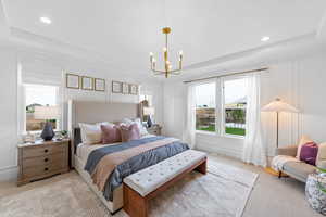 Carpeted bedroom featuring a chandelier