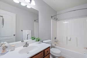 Full bathroom featuring bathtub / shower combination, toilet, and vanity