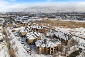 Snowy aerial view featuring a mountain view