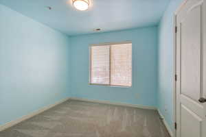 Spare room with light colored carpet