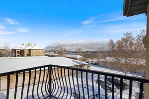 View of snow covered back of property