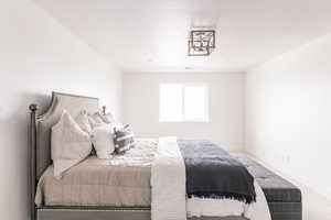 Carpeted bedroom featuring a textured ceiling