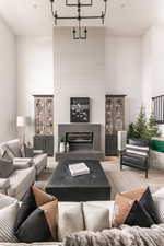 Living room with light hardwood / wood-style flooring and an inviting chandelier