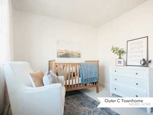 Carpeted bedroom featuring a crib