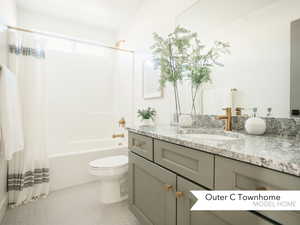 Full bathroom featuring vanity, toilet, tile patterned floors, and shower / bath combo with shower curtain