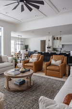 Living room featuring ceiling fan and ornamental molding