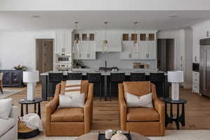 Living room featuring crown molding and light hardwood / wood-style floors