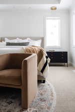 Carpeted bedroom featuring ornamental molding