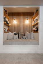 Sitting room featuring wood walls and carpet flooring