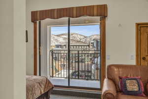 Bedroom with a mountain view and access to outside