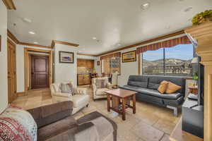 Living room featuring crown molding and a mountain view