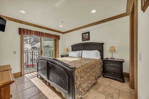 Bedroom featuring ornamental molding and access to outside