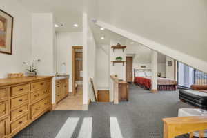 Carpeted bedroom with ensuite bathroom