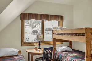 Bedroom featuring vaulted ceiling