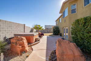 View of patio with french doors and a hot tub