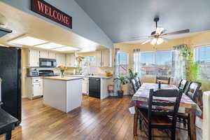 Kitchen with black appliances, a center island, white cabinetry, dark hardwood / wood-style flooring, and sink