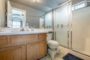 Bathroom with vanity, toilet, and an enclosed shower