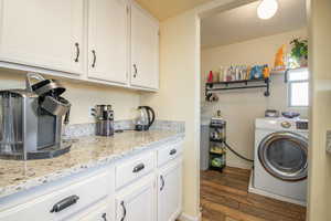 Laundry room featuring dark hardwood / wood-style floors and washer / clothes dryer