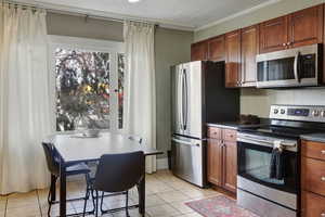 Beautiful kitchen with dining space and beautiful molding throughout