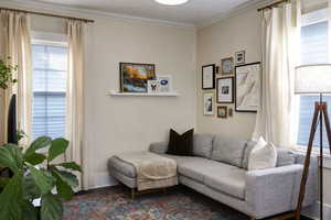 Living room featuring crown molding