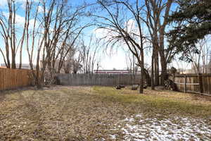 View of nice deep, fenced backyard