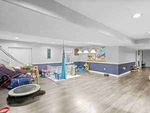 Playroom with wood-type flooring