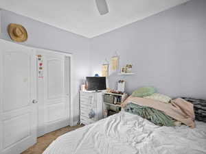 Carpeted bedroom featuring ceiling fan