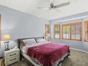 Bedroom with ceiling fan and carpet flooring