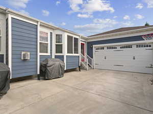 View of side of property with a garage