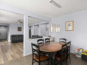 Dining room featuring ceiling fan and tile patterned flooring