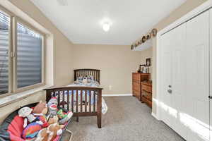 Carpeted bedroom featuring a closet