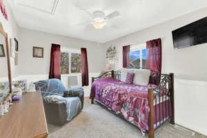 Bedroom with ceiling fan and multiple windows