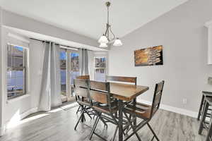 Dining room featuring an inviting chandelier and light hardwood / wood-style floors