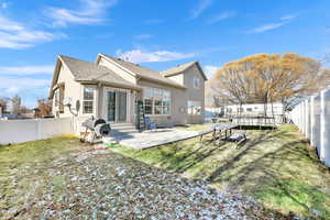 Rear view of property featuring a patio area and a lawn