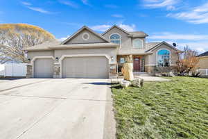 View of front of house featuring a front yard and a garage