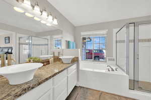 Bathroom with hardwood / wood-style floors, plus walk in shower, and vanity