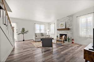 Living room featuring wood-type flooring and a fireplace