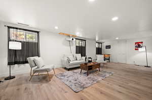 Living room with light hardwood / wood-style flooring