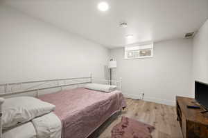 Bedroom with light hardwood / wood-style floors