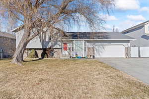 View of front facade with a front yard and a garage