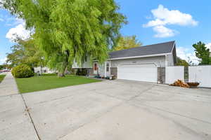 View of front of home featuring a garage and a front yard